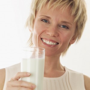 Cheerful Woman Holding Glass of Milk