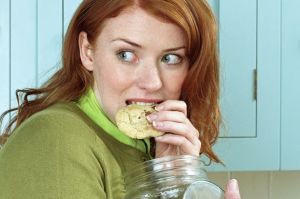 Woman secretly eating cookies